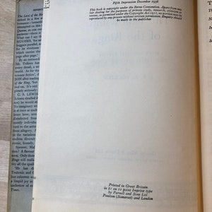 May include: A close-up of a book's copyright page with details about the book's publication history, including the first publication date, subsequent printings, and copyright information. The text includes the title "The Lord of the Rings" and the author's name, J.R.R. Tolkien.