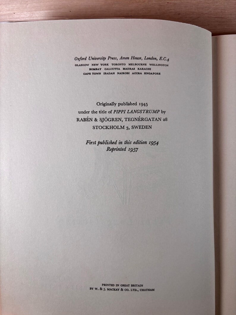 May include: A white book copyright page with black text. It lists Oxford University Press, London, and notes the book was originally published in 1945 as PIPPI LANGSTRUMP by RAB&Eacute;N & SJ&Ouml;GREN, STOCKHOLM, SWEDEN. This edition was published in 1954 and reprinted 1957.