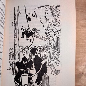 May include: A black and white book illustration depicting a person swinging from a rope attached to a tree branch. Below, two figures in uniform operate a water pump, spraying a stream of water toward a building while onlookers watch the scene.