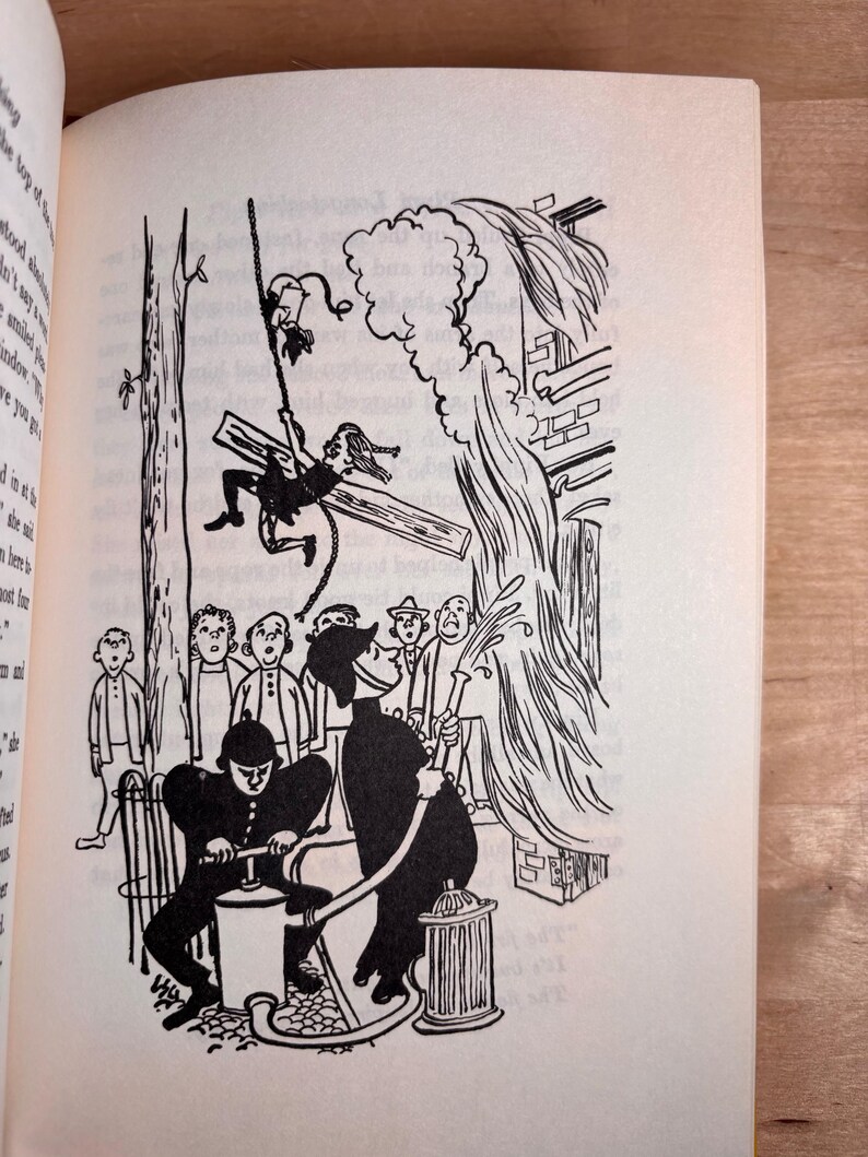 May include: A black and white book illustration depicting a person swinging from a rope attached to a tree branch. Below, two figures in uniform operate a water pump, spraying a stream of water toward a building while onlookers watch the scene.