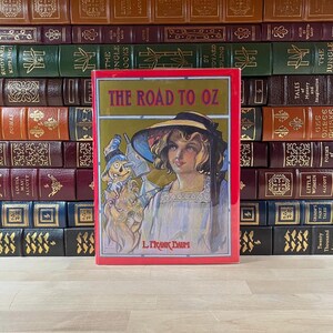 Vintage, 1991 Nachdruck von The Road to Oz von L. Frank Baum, illustriert von John R. Neill, Originaler Schutzumschlag, gedruckt auf farbigem Papier