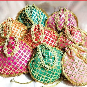 May include: Assortment of colorful drawstring pouches with gold trim and pearl embellishments. Each pouch features a checkered pattern with gold accents.