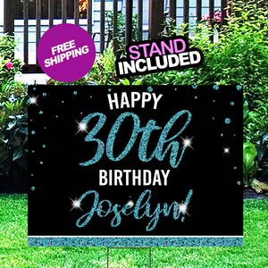 May include: A black and blue glitter birthday sign with the text "Happy 30th Birthday Jocelyn!" The sign has a blue glitter border and a white background.