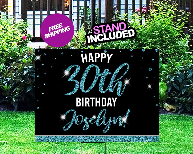 May include: A black and blue glitter birthday sign with the text "Happy 30th Birthday Jocelyn!" The sign has a blue glitter border and a white background.