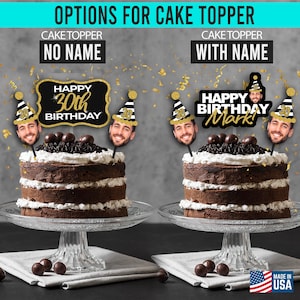 May include: Two cake toppers with a black and gold design. The topper on the left says "Happy 30th Birthday". The topper on the right says "Happy Birthday Mark!" Both toppers feature a black and white striped party hat with a gold star.