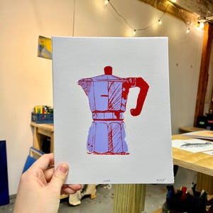May include: A red and blue illustration of a coffee pot on a white background. The illustration is titled "Moka" and signed "EC207".