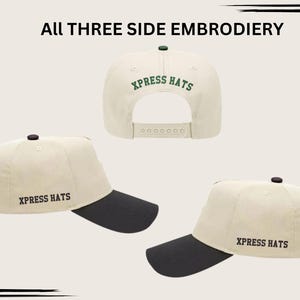 May include: Cream-colored baseball cap with a black brim and a black button on top. The text "XPRESS HATS" is embroidered on the side and back of the cap. The image shows three different views of the hat.