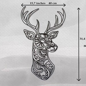 May include: Black and white line art wall decor of a deer head with intricate patterns. The deer head measures 15.7 inches wide and 31.4 inches tall.