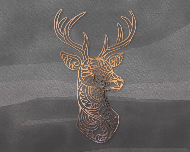 May include: A gold-colored deer silhouette with intricate patterns and designs. The deer's head is turned to the side, and its antlers are spread wide.