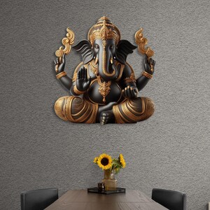 May include: A black and gold Ganesh statue in a seated pose, mounted on a gray textured wall. The statue features intricate details and ornate gold accents. The room includes a dark wooden table with sunflowers in a vase.