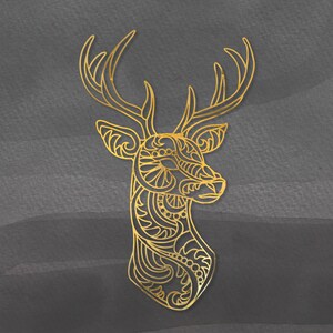 May include: A gold-colored, intricate, decorative deer head silhouette with a detailed design. The deer head is isolated against a dark gray background.
