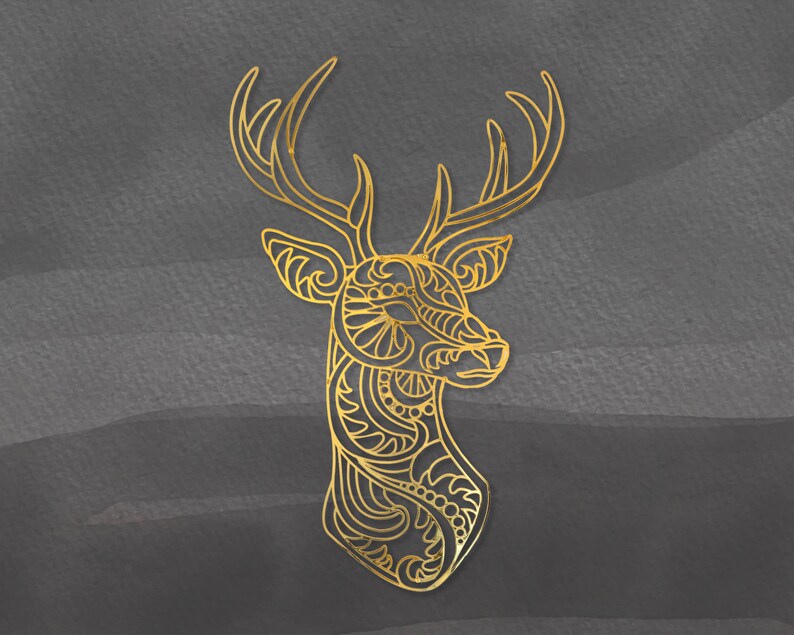 May include: A gold-colored, intricate, decorative deer head silhouette with a detailed design. The deer head is isolated against a dark gray background.