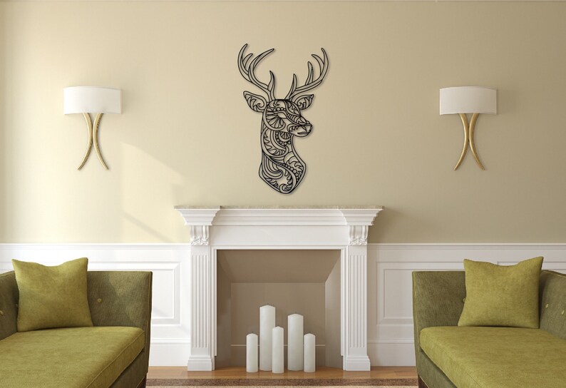 May include: A black metal deer head wall decor with intricate cut-out designs. The deer head is mounted on a white wall with a white fireplace below it.