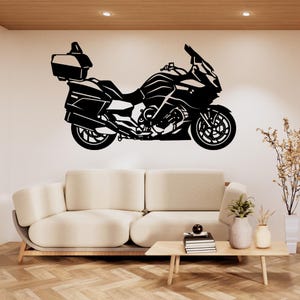 May include: Black motorcycle wall art. The motorcycle is a detailed silhouette with a top case and fairing. The image is a graphic design, suitable for a motorcycle enthusiast's decor. The motorcycle is shown in profile.