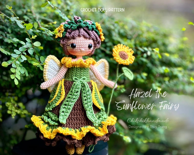 May include: Crochet doll pattern for Hazel the Sunflower Fairy. The doll is wearing a green and brown dress with yellow sunflower accents. The doll has brown hair and a sunflower crown.