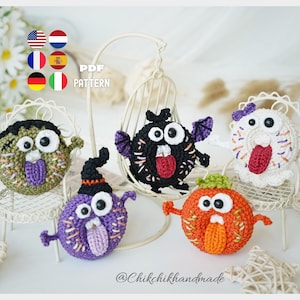 May include: Five round, crocheted doughnut-shaped creatures with large white eyes, protruding tongues, and small arms. The figures are green, black with purple wings, white with a purple bow, purple with a black hat, and orange. Text reads PDF PATTERN.