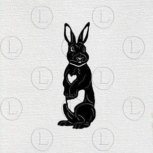 May include: A black silhouette of a rabbit standing upright, with a heart-shaped cutout on its chest. The rabbit has long ears and is set against a textured, off-white background with repeating circular patterns.