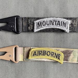 Tactical Clip Velcro loop strip on one side, Multicam and Multicam Black attach badges HK steel clip and d-ring mil spec webbing 1 inch