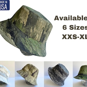 May include: A green, brown and black camouflage bucket hat. Available in 6 sizes: XXS-XL. Made in the USA.