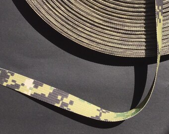 May include: A close-up of a roll of camouflage-patterned webbing. The webbing is green, black, and tan.