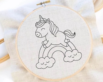 May include: A black and white line drawing of a unicorn standing on a rainbow with clouds. The unicorn has a horn, mane, and tail. The rainbow has a curved shape and is surrounded by clouds.