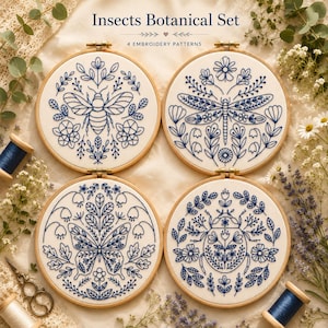 May include: Four circular wooden embroidery hoops containing white fabric with blue thread designs of a bee, a dragonfly, a butterfly, and a beetle surrounded by botanical elements. The text Insects Botanical Set 4 EMBROIDERY PATTERNS is visible.