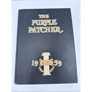 May include: A black hardcover book titled "The Purple Patcher" with gold lettering. The book features a gold emblem with the numbers "19" and "59" on either side of a pillar design. The book's cover has a textured appearance.