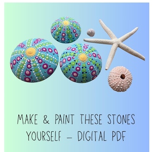 May include: Three painted stones with a blue background, decorated with colorful dots and a yellow center. A white starfish, a small shell, and a pink sea urchin are also present. The text reads: "MAKE & PAINT THESE STONES YOURSELF - DIGITAL PDF."