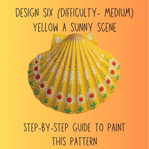 Op de afbeelding: Een geschilderde gele zeeschelp met een zonnige scène ontwerp. De schelp is versierd met witte en rode bloempatronen en groene accenten. Tekst op de afbeelding luidt "DESIGN SIX (DIFFICULTY- MEDIUM) YELLOW A SUNNY SCENE" en "STEP-BY-STEP GUIDE TO PAINT THIS PATTERN."