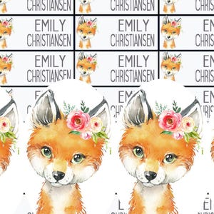 May include: Sheet of personalized labels featuring watercolor illustrations of foxes with floral crowns. Each label includes the name "EMILY CHRISTIANSEN". The labels are rectangular with a white background and black text.