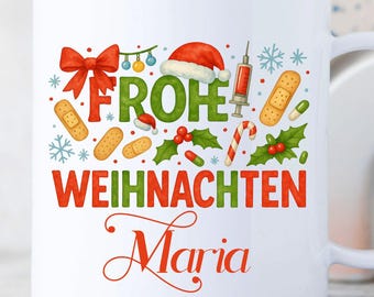 May include: White ceramic mug with a Christmas-themed design. The mug features the words "FROHE WEIHNACHTEN Maria" in red and green, along with festive illustrations of a Santa hat, bow, snowflakes, and medical elements.