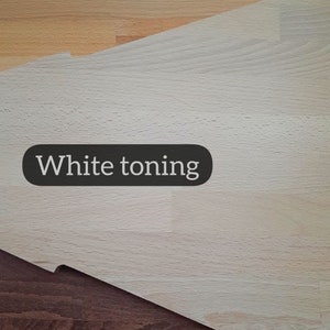May include: Image showcasing three wood samples with different finishes. The top section displays a natural wood tone, followed by a white-toned section, and a dark-toned section at the bottom. Each section has a label: "Natural", "White toning", and "Dark toning".