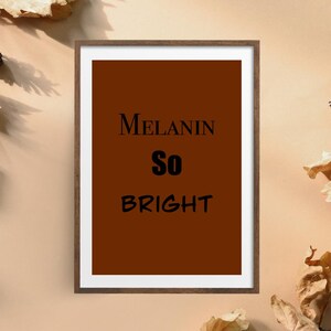 May include: A framed print with a brown background and the text "MELANIN SO BRIGHT" in black.