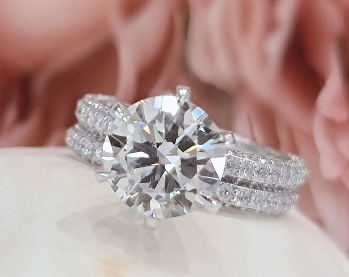 This unique ring set features a 3 Carat  Round Brilliant cut IGI certified CVD lab grown diamond accompanied by a matching flushing diamond wedding band
