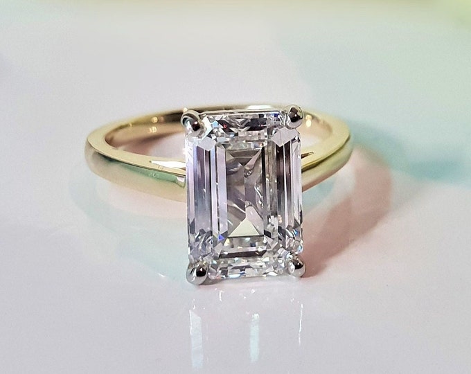 This classic 2 tone 18K gold cathedral setting features a 4 carat emerald cut IGI certified CVD lab grown diamond