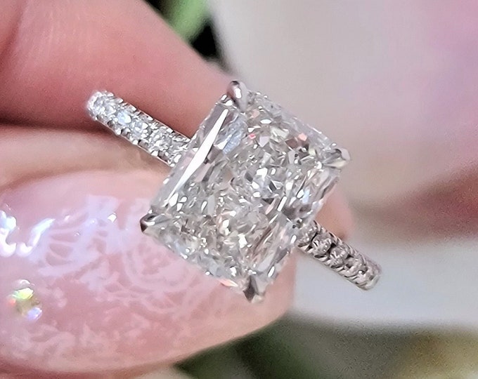 This classic diamond pave setting features a 3 carat IGI certified CVD lab grown radiant cut diamond & 0.34 carats accent diamonds