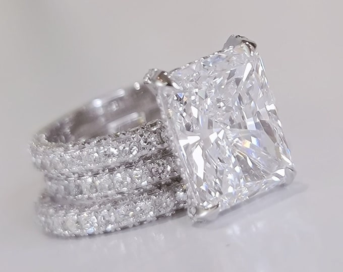 Elegant 4CT CVD Radiant diamond with 1CT side stones, paired with two 0.79CT matching wedding bands.