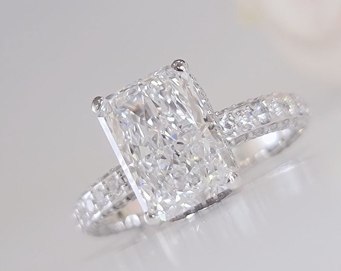 This Elegant white gold 3D pave diamond setting features 1.50 carats accent diamonds and a 4 carat IGI Certified CVD lab grown elongated Radiant cut diamond
