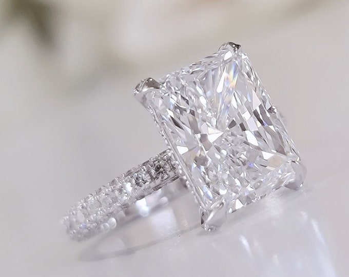 This Elegant 18K diamond setting features a 4 carat IGI Certified CVD lab grown elongated Radiant cut diamond and 1.02ct accent diamonds