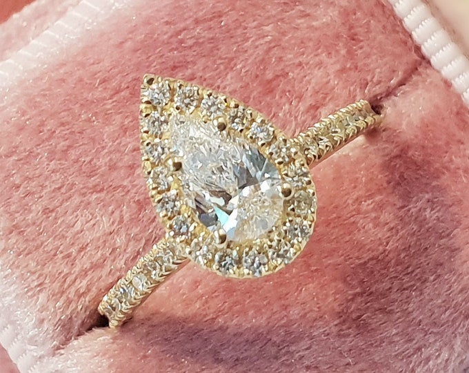 This unique Halo Solitaire diamond setting features a 1 carat Pear Cut IGI Certified CVD lab grown diamond and 0.35 carats accent diamonds