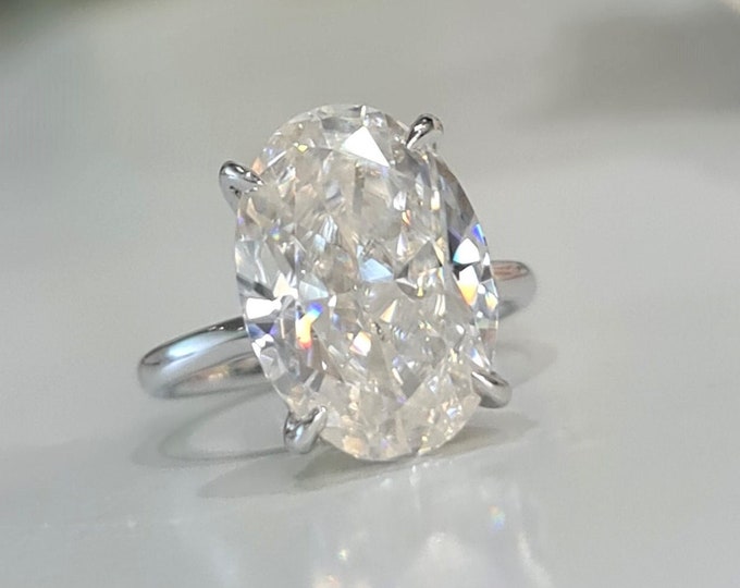 This classic solitaire 18K white gold setting features a 4 carat Oval Cut IGI certified CVD lab grown diamond