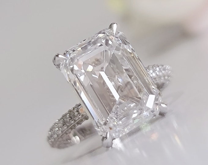 This dainty elegant pave diamond setting features a 5.5 carat IGI certified CVD lab grown emerald cut diamond & 0.75 carats accent diamonds