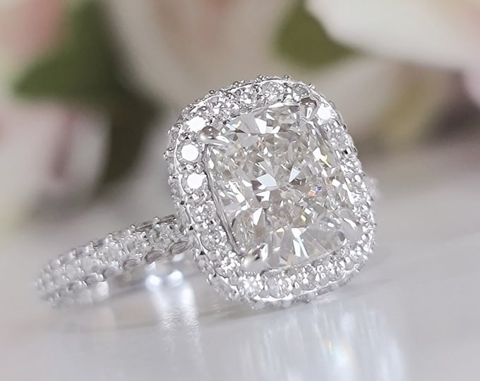 This unique double edge halo 14K gold diamond setting features a 2 carat IGI certified CVD lab grown cushion cut diamond & 1.43 carats accent diamonds