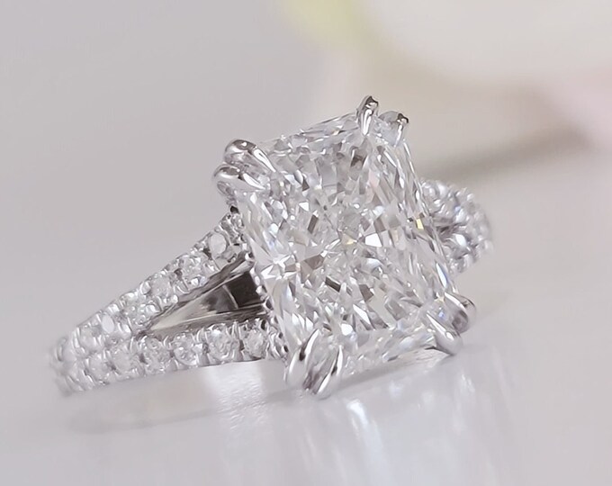 This elegant  14k gold split shank diamond setting features a 2 carat elongated radiant cut IGI certified CVD lab grown diamond