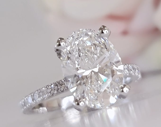 This hidden halo invisible gallery setting features a 3 carat IGI Certified CVD lab Grown diamond & 0.74ct accent diamonds