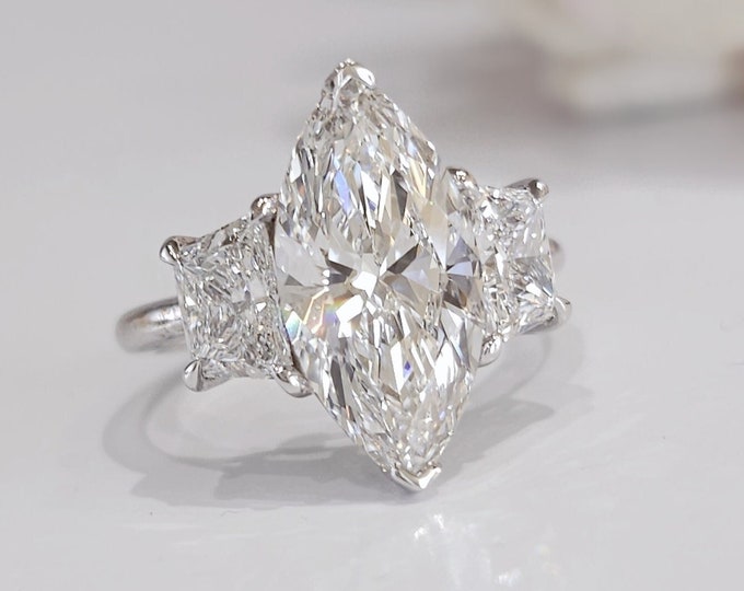This Victorian style cathedral setting features a unique single prong 0.50 carats diamond halo and is set with a 3 carat center oval cut diamond