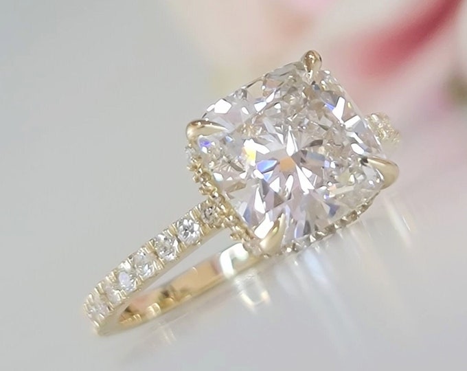 This classic 14K Yellow Gold hidden halo setting features a 3 carat IGI certified CVD lab grown cushion cut diamond & 0.47 carats accent diamonds