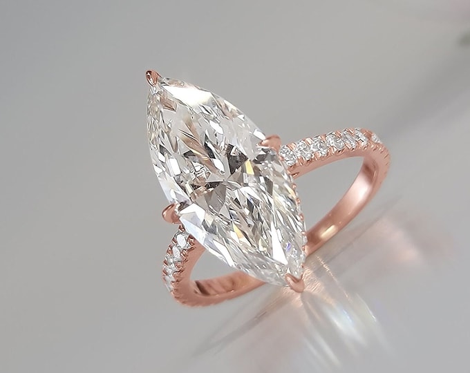 This Unique hidden halo Engagement Ring features a  4 Carat IGI Certified CVD lab grown Marquise Cut diamond accentuated  with 0.57 carats  side diamonds