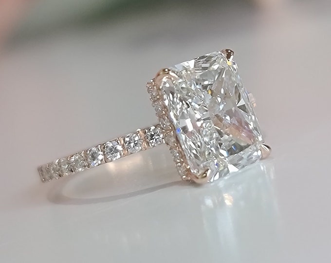 This 14k Rose Gold Unique invisible gallery and hidden halo diamond setting features a 3 Carat Radiant Cut IGI Certified CVD lab grown diamond
