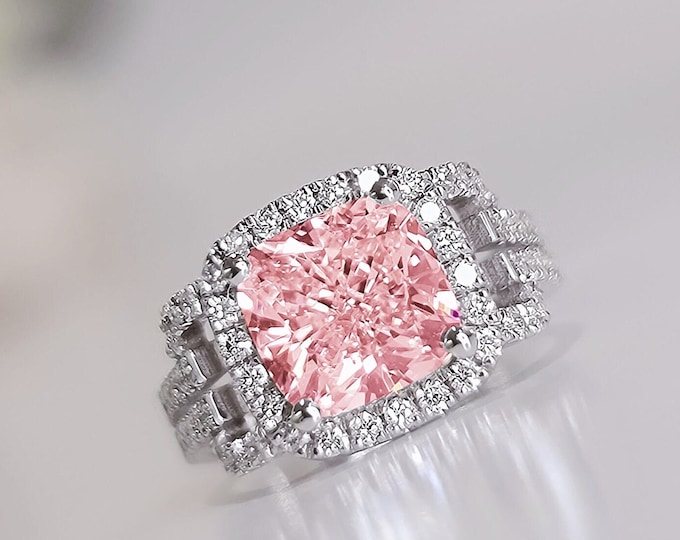This unique split shank with pave diamond & halo setting features a 4 Carat Pink Cushion Cut IGI Certified CVD lab grown diamond and 0.76 carats accent diamonds